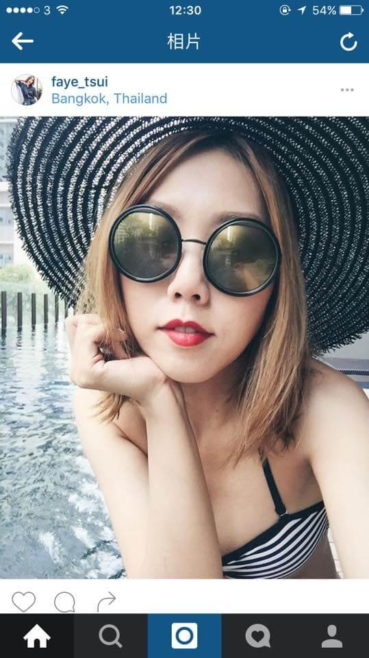 Woman in striped bikini by pool wearing large round sunglasses and a wide-brim sun hat