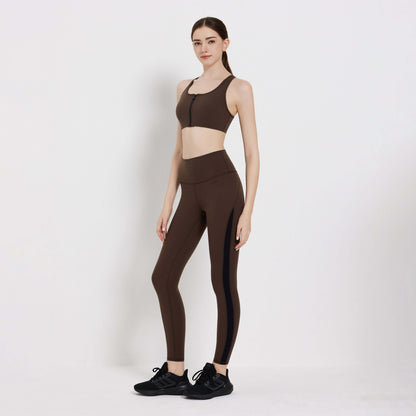 Model wearing Impact Legging in brown, styled with a matching sports bra and sneakers, showcasing activewear for fitness.