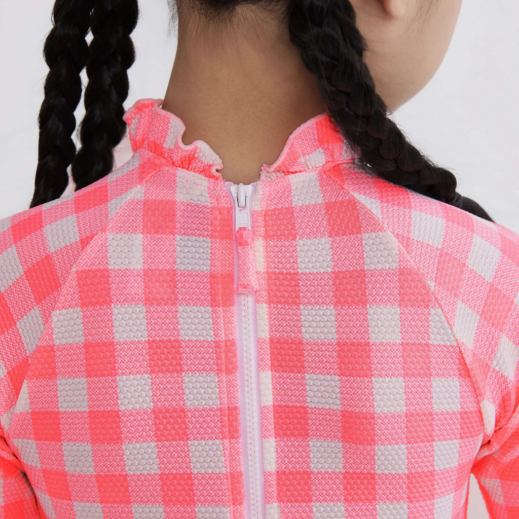 Pink and white checkered activewear top with zipper and ruffled collar