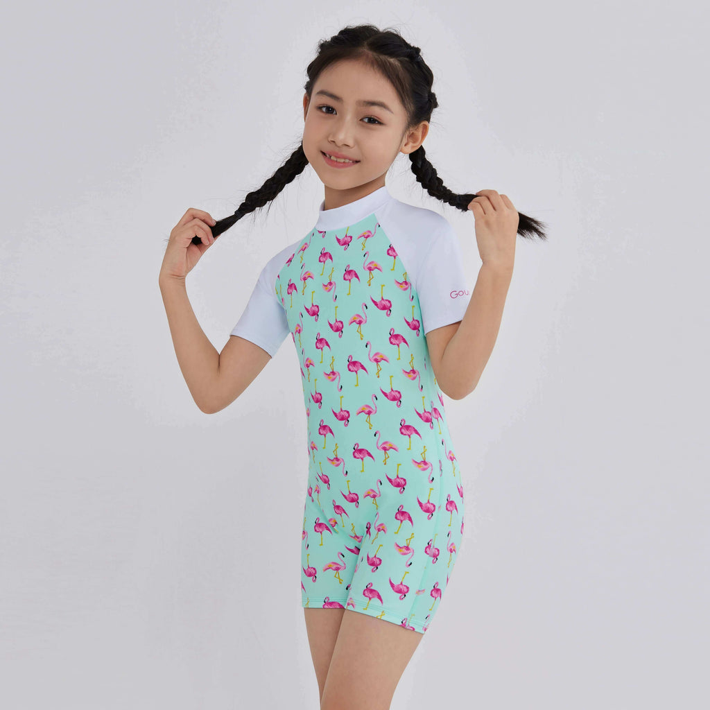 Girl in mint green flamingo print rash guard with white sleeves, perfect for swim and activewear.