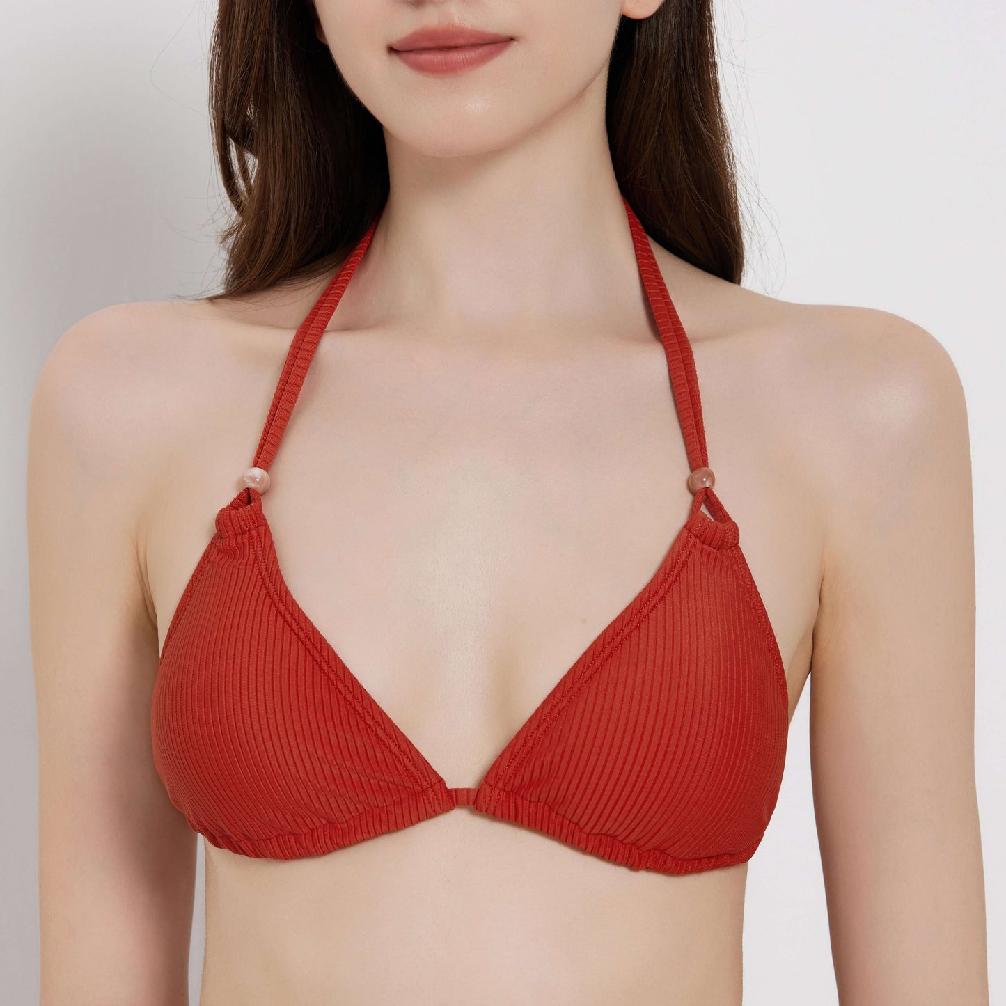 Red ribbed bikini top, perfect for beachside relaxation and summer fun.