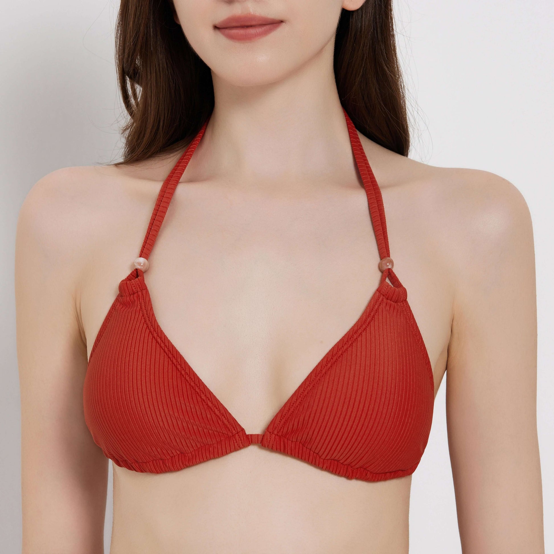 Red ribbed bikini top, perfect for beachside relaxation and summer fun.