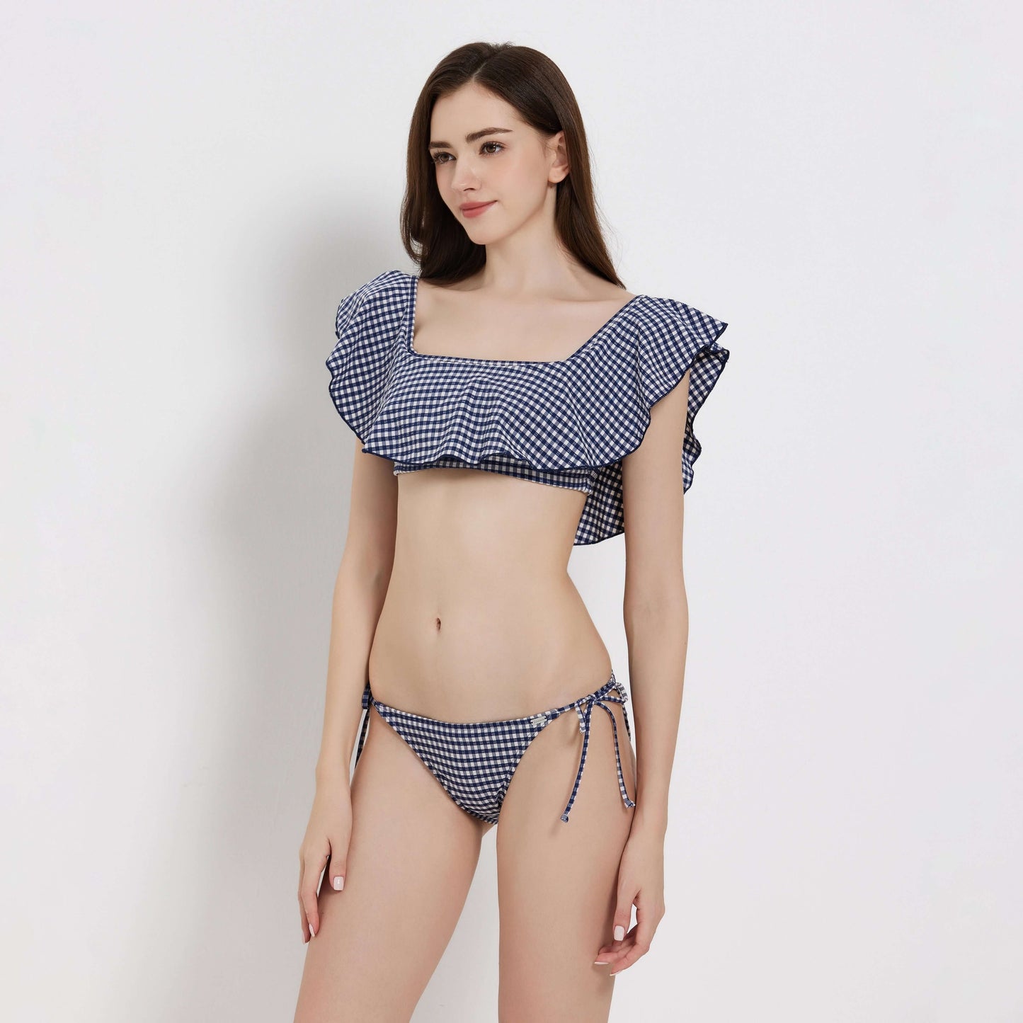 Gingham ladies bikini featuring a ruffled top and tie-side bottoms, perfect for stylish summer swims.