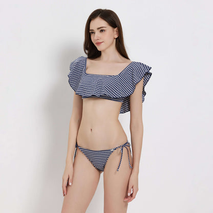 Gingham ladies bikini featuring a ruffled top and tie-side bottoms, perfect for stylish summer swims.