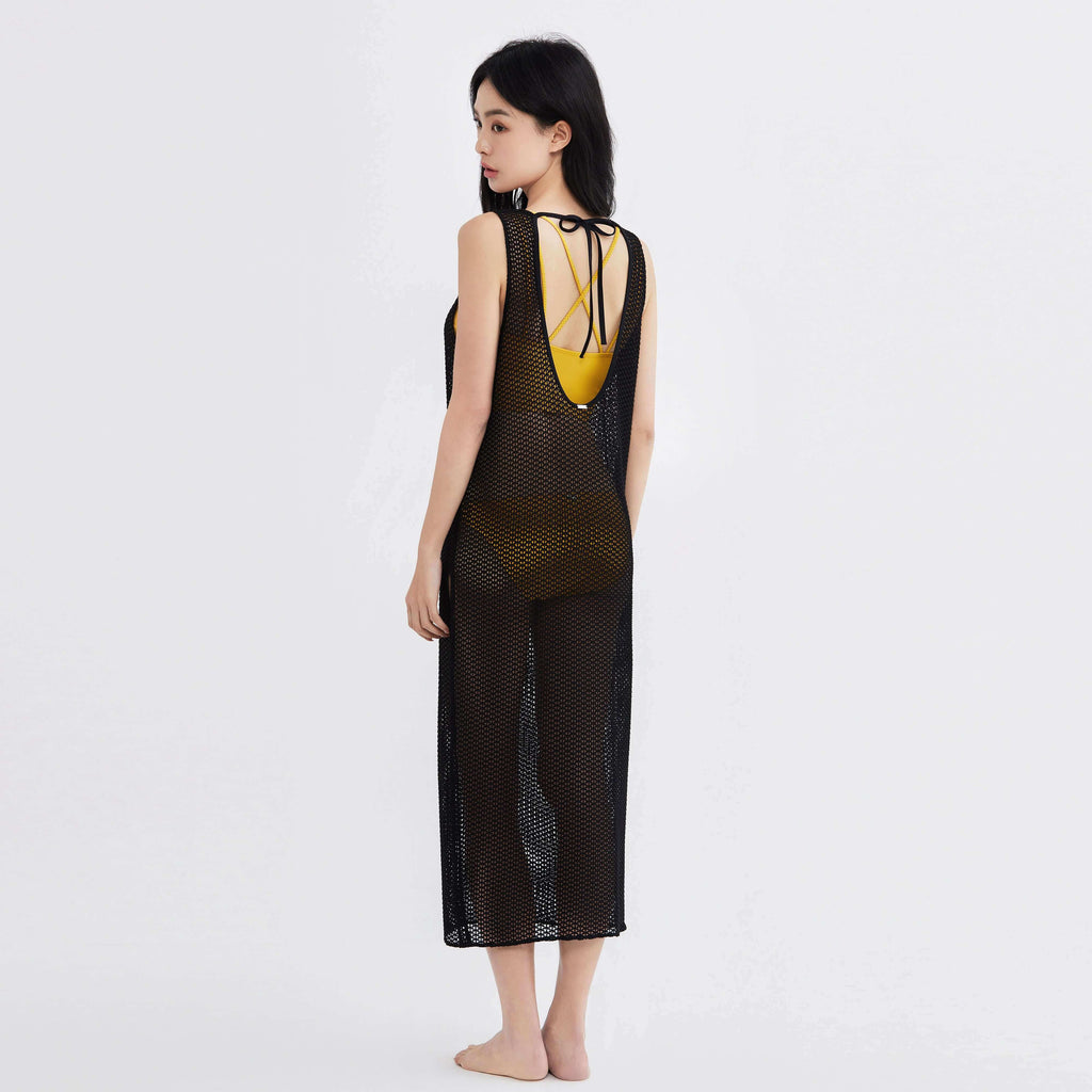 Black mesh cover-up over yellow swimwear, stylish and functional for beach to street wear.