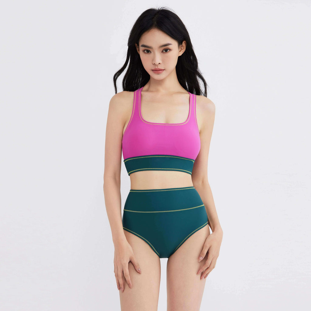 Woman modeling pink and green high-waisted swimwear with gold trim, designed for active movement and style.