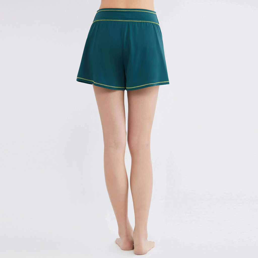 Teal activewear shorts with yellow trim, designed for comfort and movement.