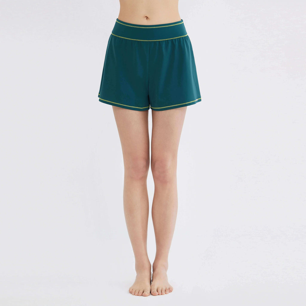Teal swim shorts with lime trim, designed for comfort and movement, perfect for swim and activewear.