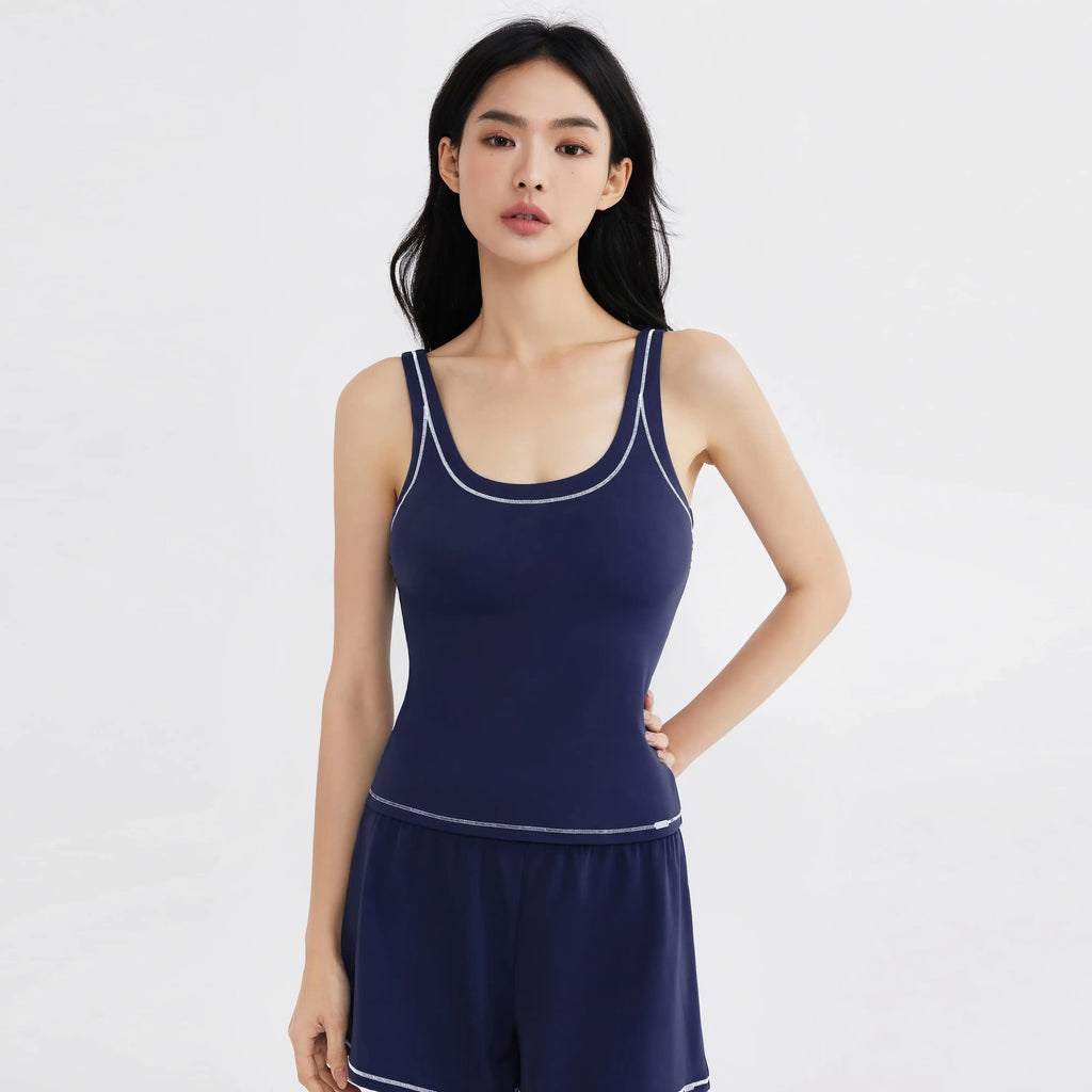 Navy blue activewear tank top with white trim, designed for comfort and movement, perfect for swim or daily wear.