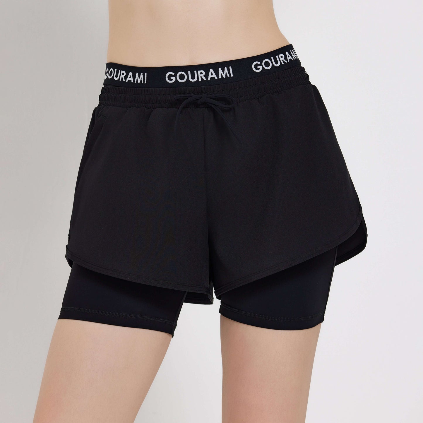Gourami Band Ladies Boardshorts in black featuring a stylish layered design and comfortable waistband.