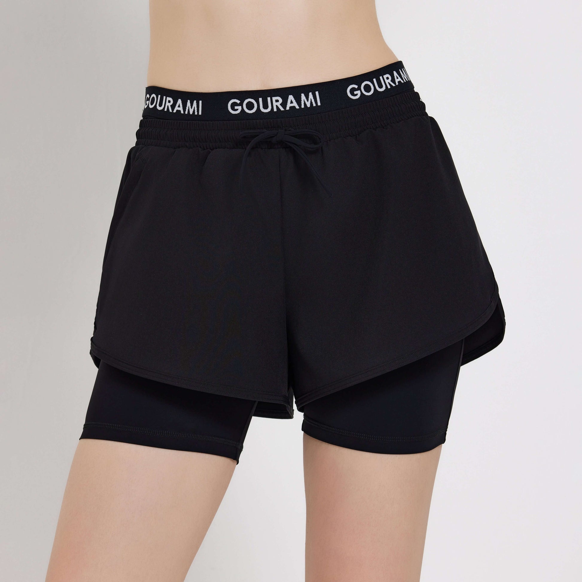 Gourami Band Ladies Boardshorts in black featuring a stylish layered design and comfortable waistband.