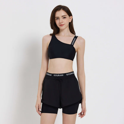 Gourami Band ladies boardshorts model wearing stylish black activewear, perfect for beach or casual outings.