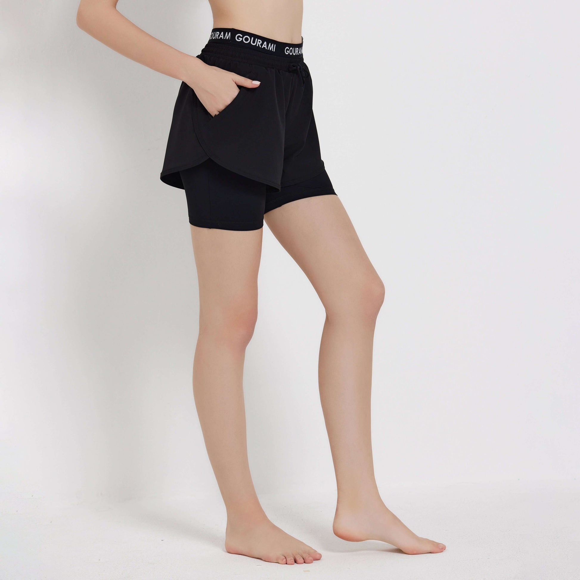 Gourami Band ladies boardshorts displayed on a model, featuring a stylish design and pockets.
