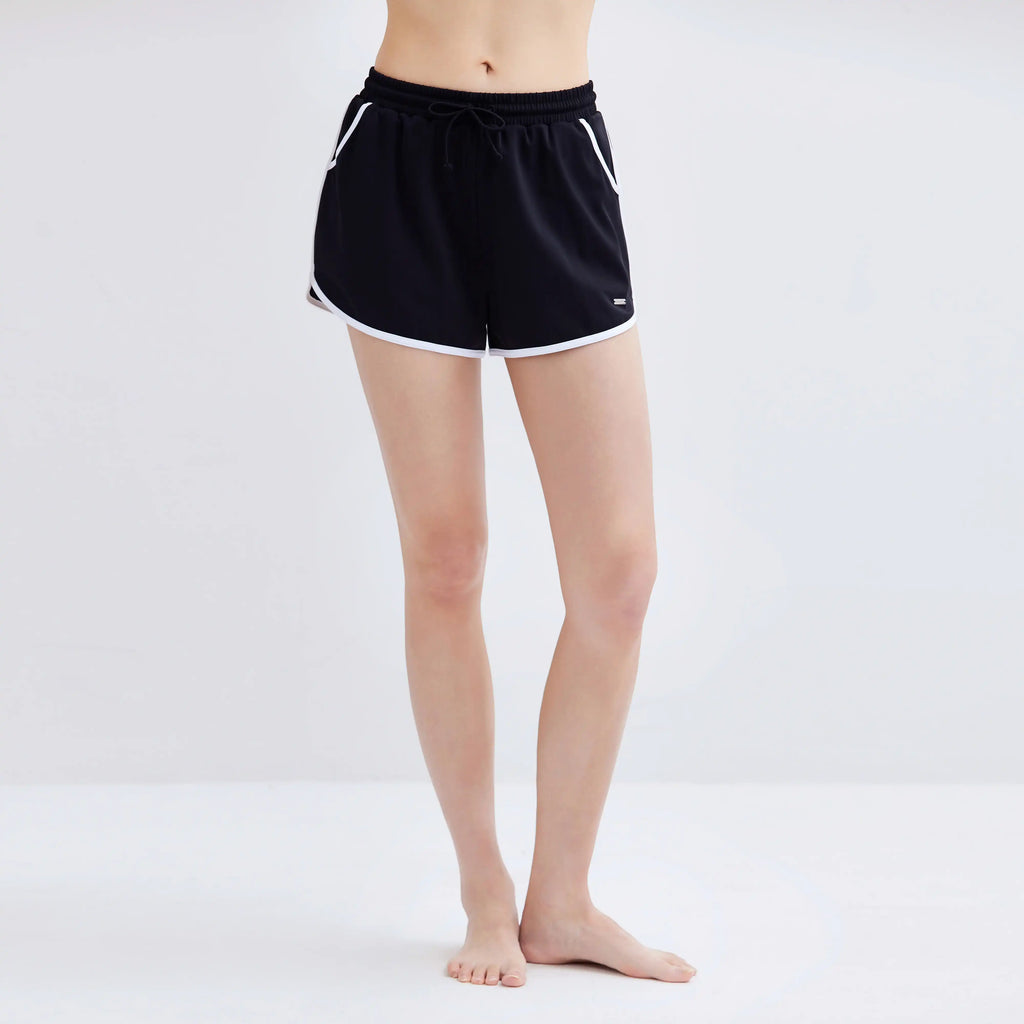 Woman wearing black Contrasting Swim Shorts with white trim and drawstring waist