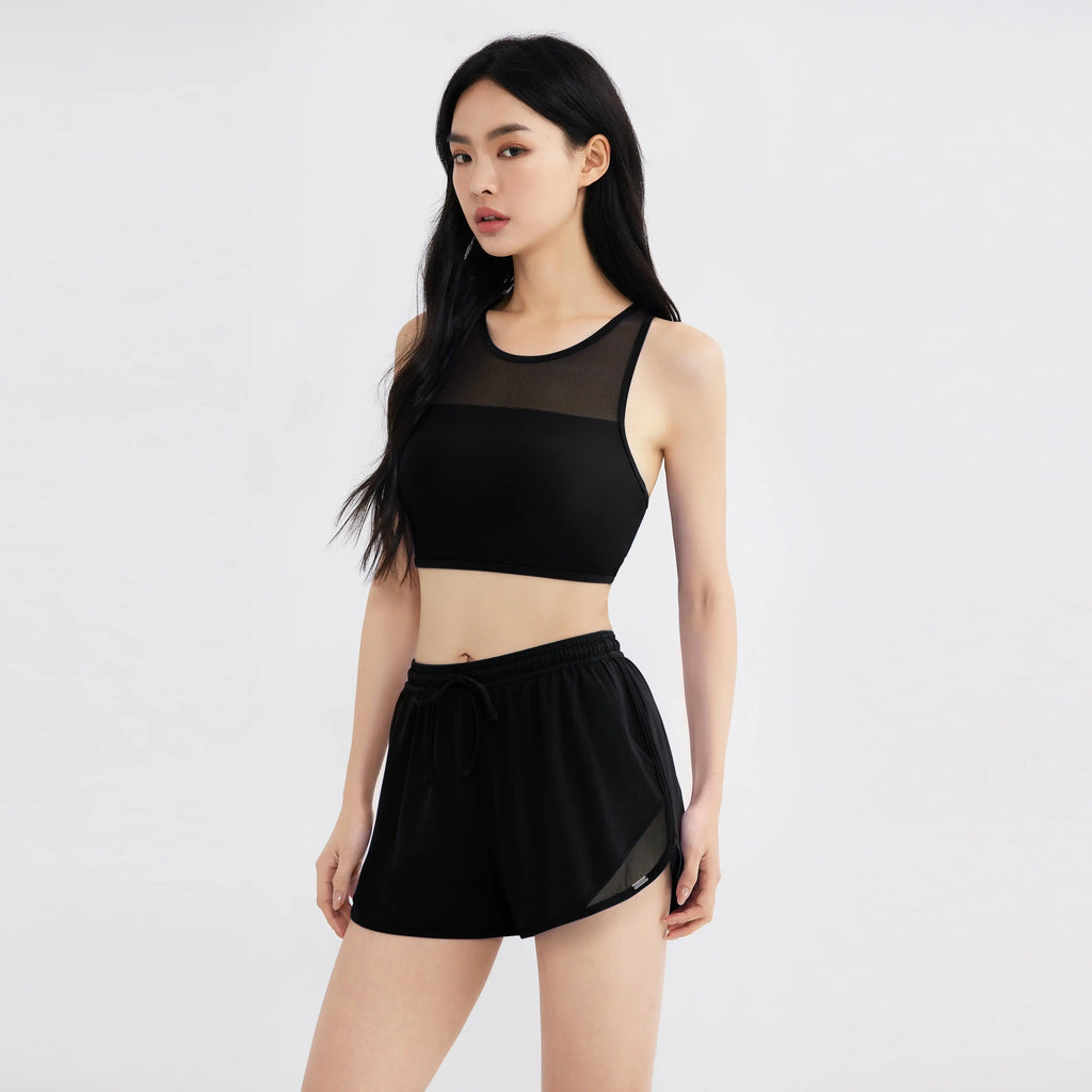 Black mesh-panel sports bra and shorts for active wear, designed for comfort and style.
