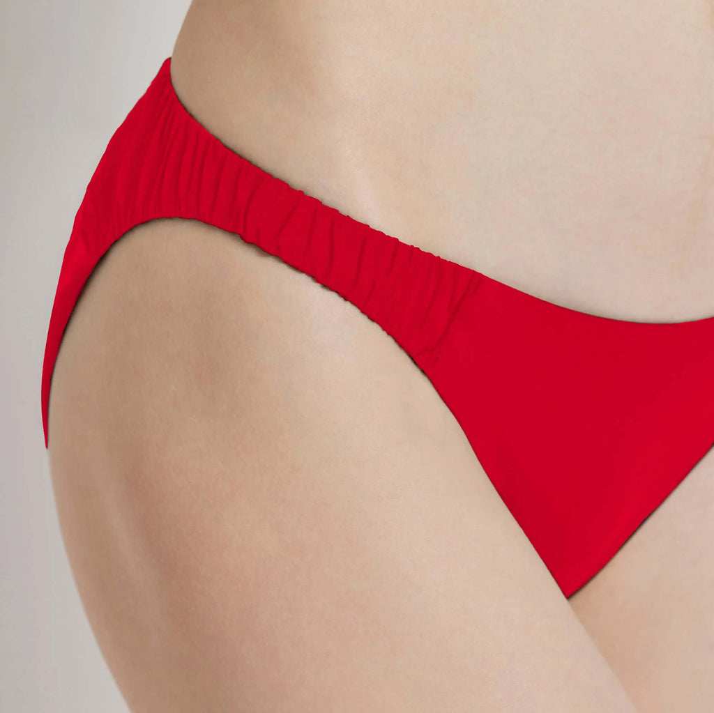 Close-up of a red Cascade Bikini bottom showcasing its flattering design and comfortable fit.