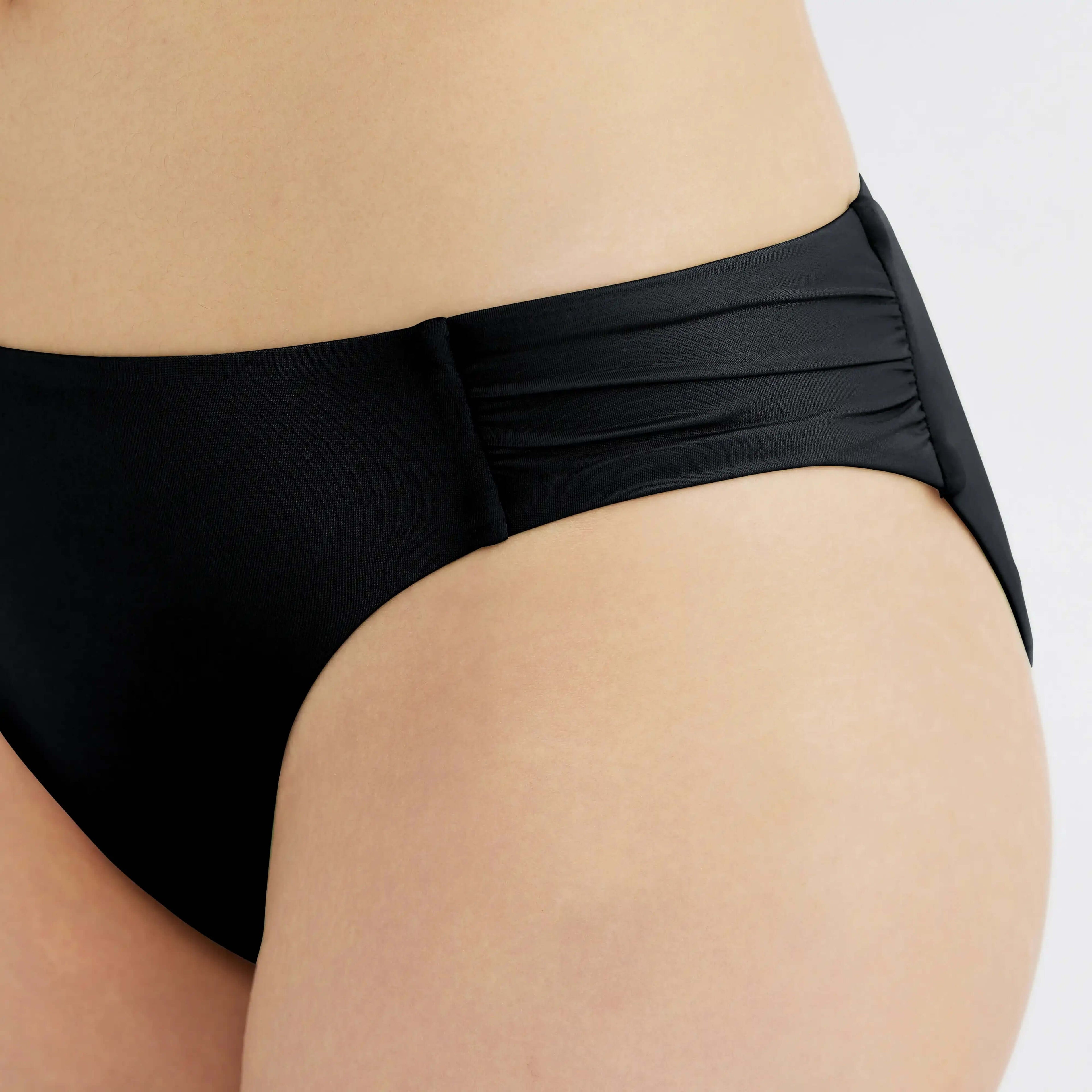 Black high-waisted bikini bottom with ruched detailing for a flattering fit